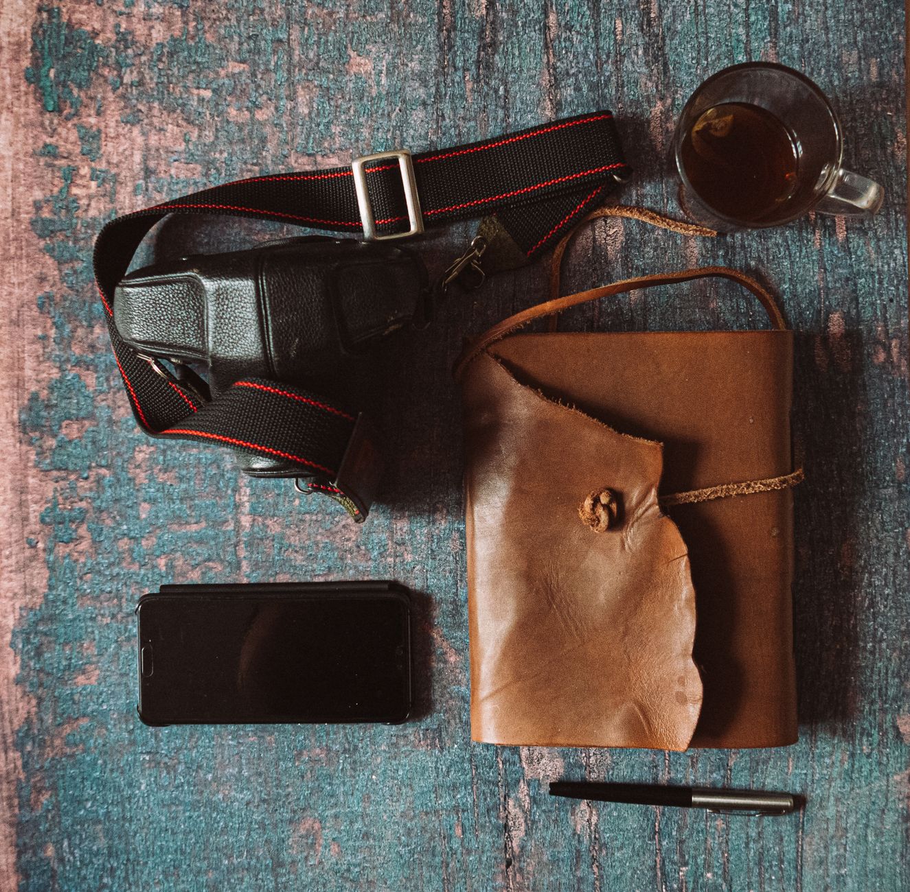 Travel author recording notes with vintage notebook against mountain vista